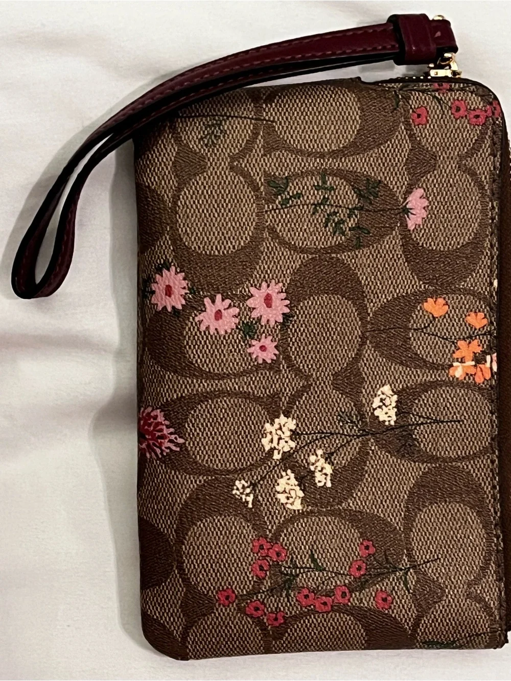 COACH Brown Signature Floral Wristlet with Gold Logo